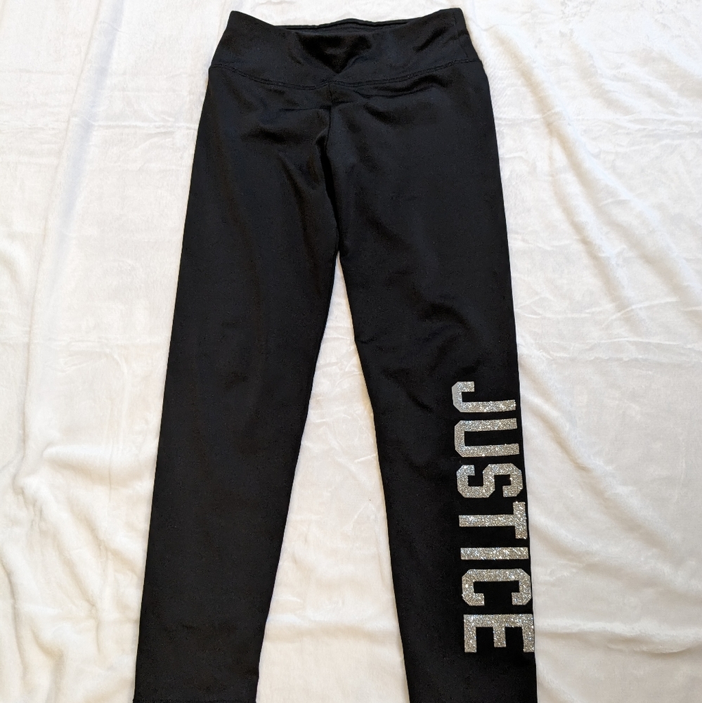 Girl's JUSTICE shiny black leggings with glitter logo down from left leg. Sz. 10